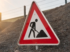 Dreieckiges Schild im Kies 