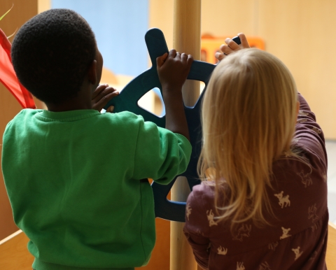 Kinderhände, die an einem Steuerrad drehen